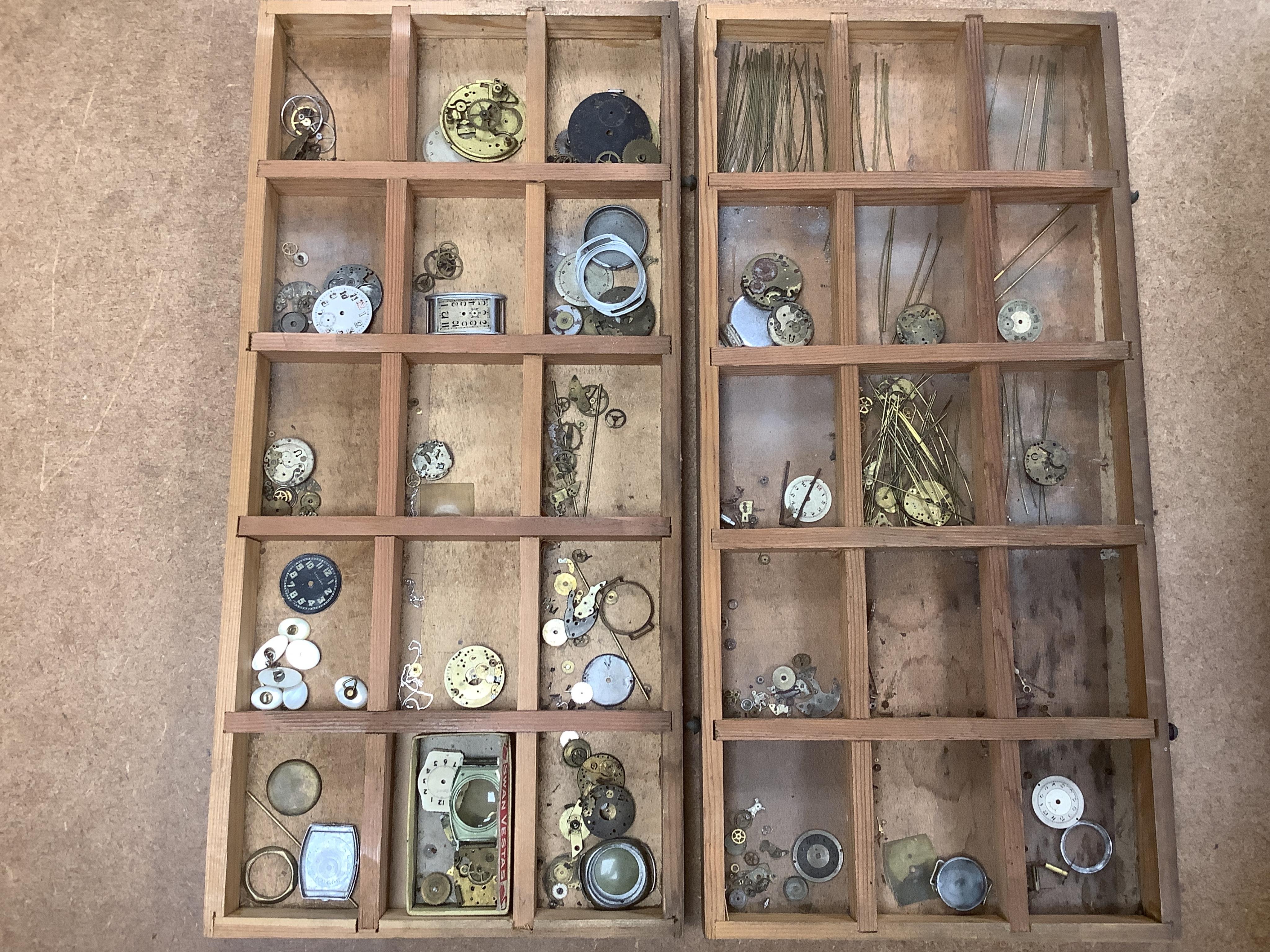 A wooden twelve drawer cabinet containing a collection of watch parts. Condition - cabinet fair to good, watch parts as found